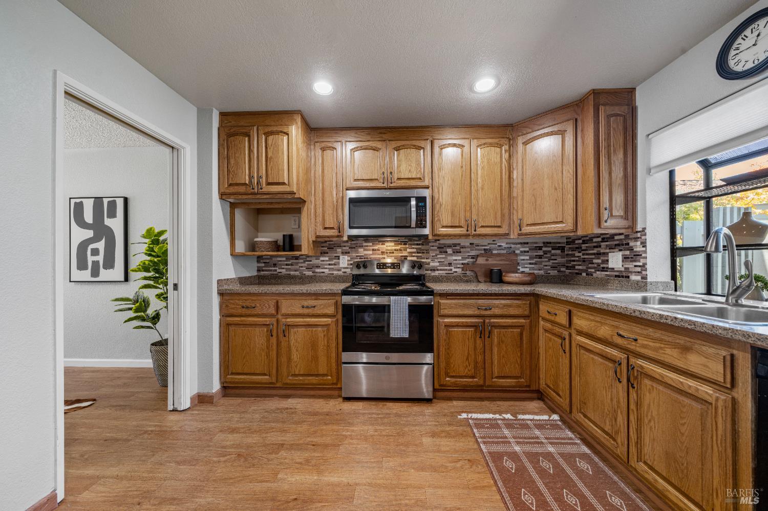 1740 Stuart Court Benicia, CA 94510 - Photo 9 of 38 a kitchen with stainless steel appliances granite countertop a stove sink and cabinets