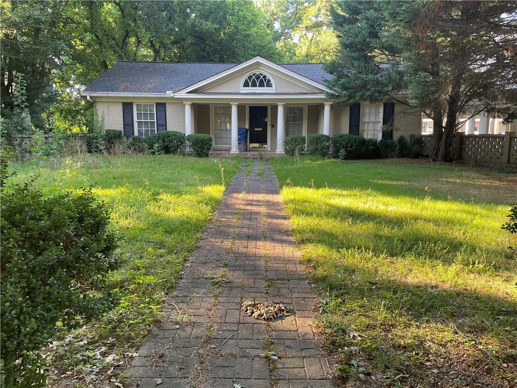a front view of a house with garden