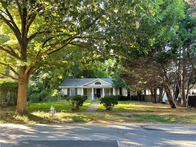 a front view of a house with a yard table and chairs