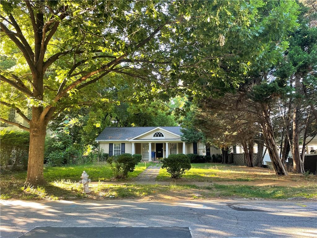 25 26th Street Northwest Atlanta, GA 30309 - Photo 3 of 6 a front view of a house with a yard table and chairs