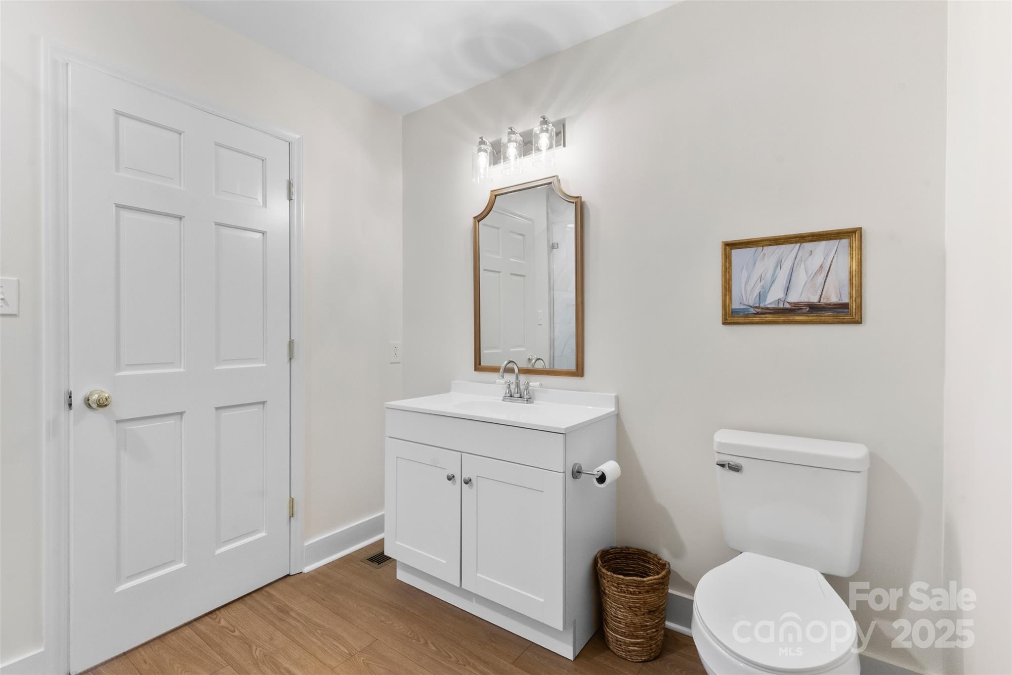 3407 Stonegate Road Monroe, NC 28110 - Photo 16 of 34 a bathroom with a toilet a sink and mirror