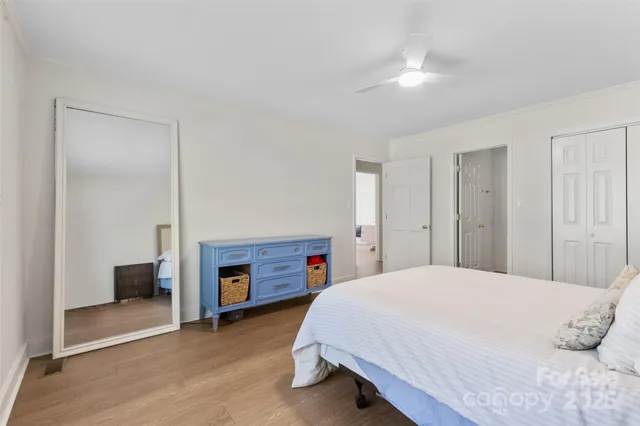 a spacious bedroom with a bed and a fireplace