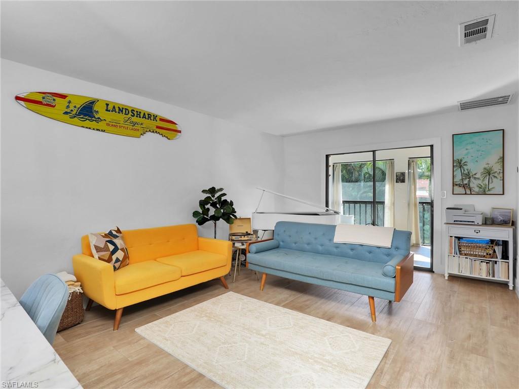 9831 Alabama Street, Unit 5 Bonita Springs, FL 34135 - Photo 13 of 28 Living room featuring light wood finished floors