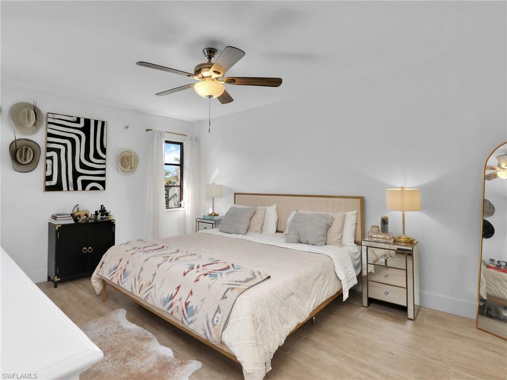 9831 Alabama Street, Unit 5 Bonita Springs, FL 34135 - Photo 16 of 28 Bedroom featuring light wood-type flooring and ceiling fan