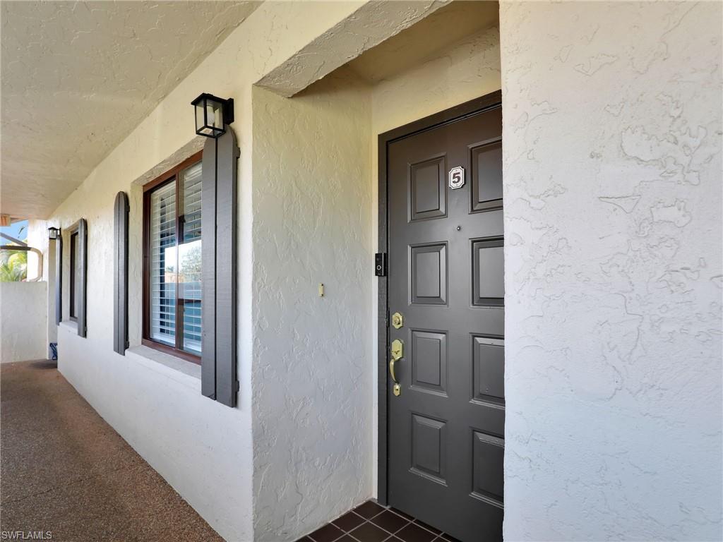 9831 Alabama Street, Unit 5 Bonita Springs, FL 34135 - Photo 3 of 28 Entrance to property with stucco siding