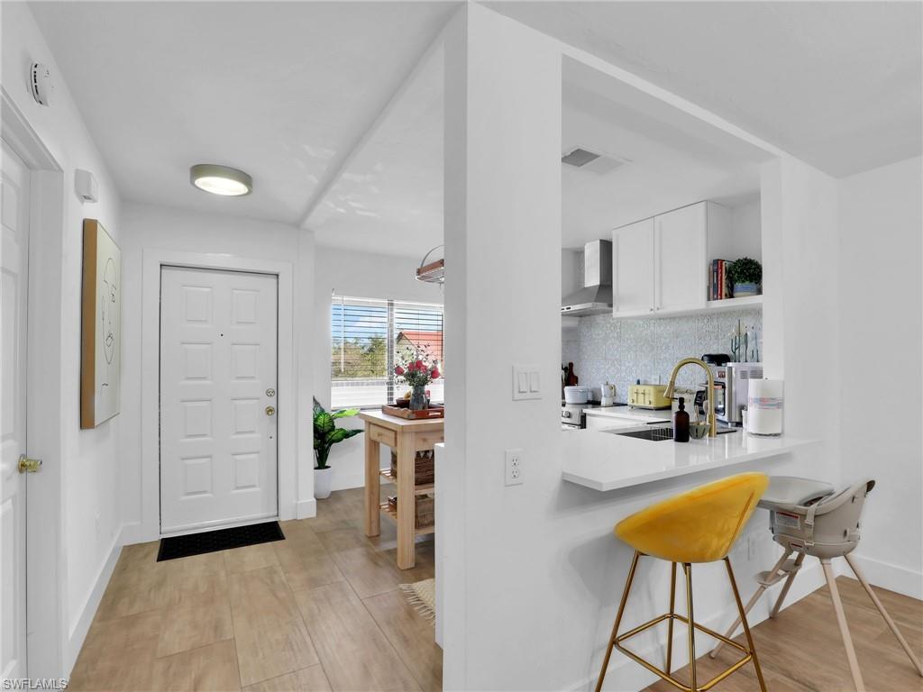 9831 Alabama Street, Unit 5 Bonita Springs, FL 34135 - Photo 5 of 28 Entrance foyer with baseboards and light wood-style flooring