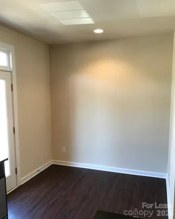 a view of an empty room and wooden floor