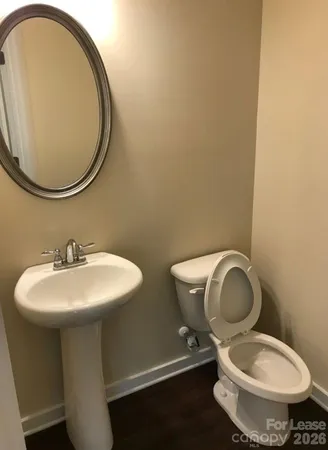 a bathroom with a toilet a sink and a mirror
