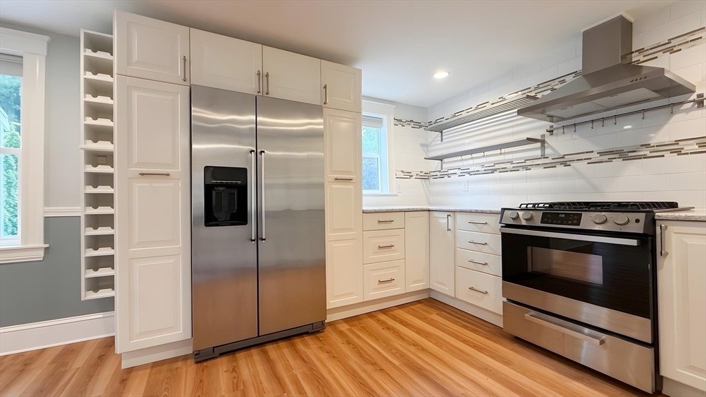 114 Curve Street Dedham, MA 02026 - Photo 10 of 27 a kitchen with stainless steel appliances a stove a microwave and a refrigerator