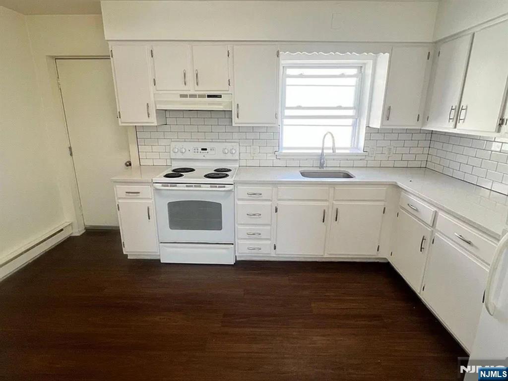 25 Houston Street, Unit 5 Newark, NJ 07105 - Photo 1 of 5 a kitchen with cabinets a sink and a stove