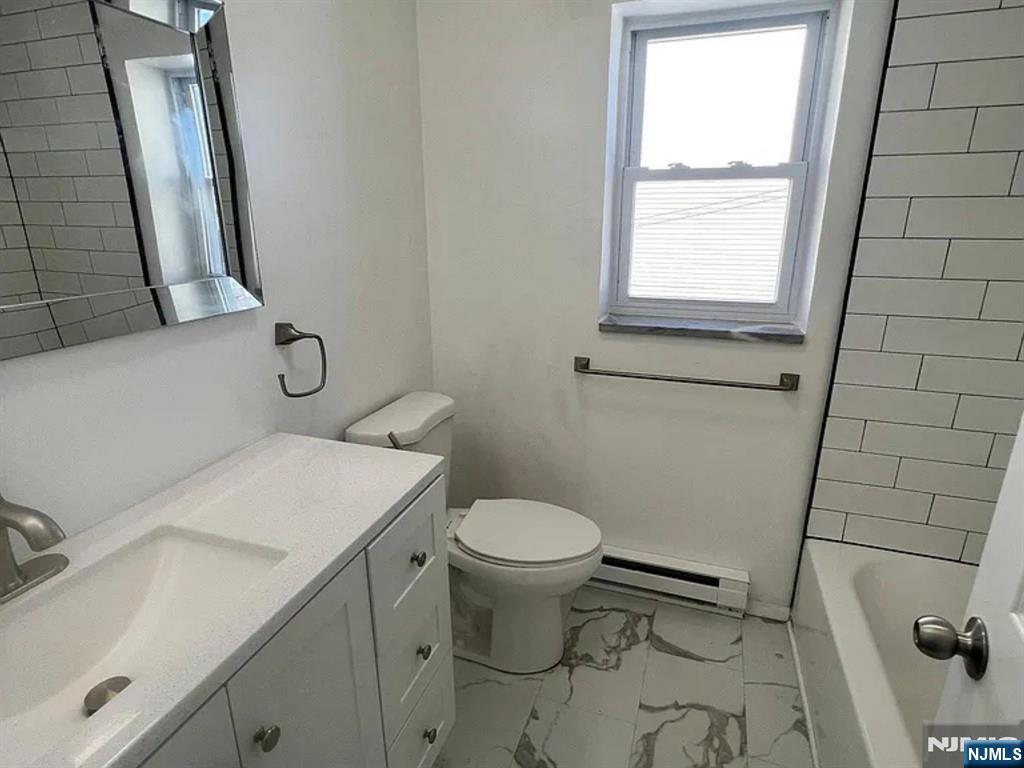 25 Houston Street, Unit 5 Newark, NJ 07105 - Photo 5 of 5 a bathroom with a sink and a toilet