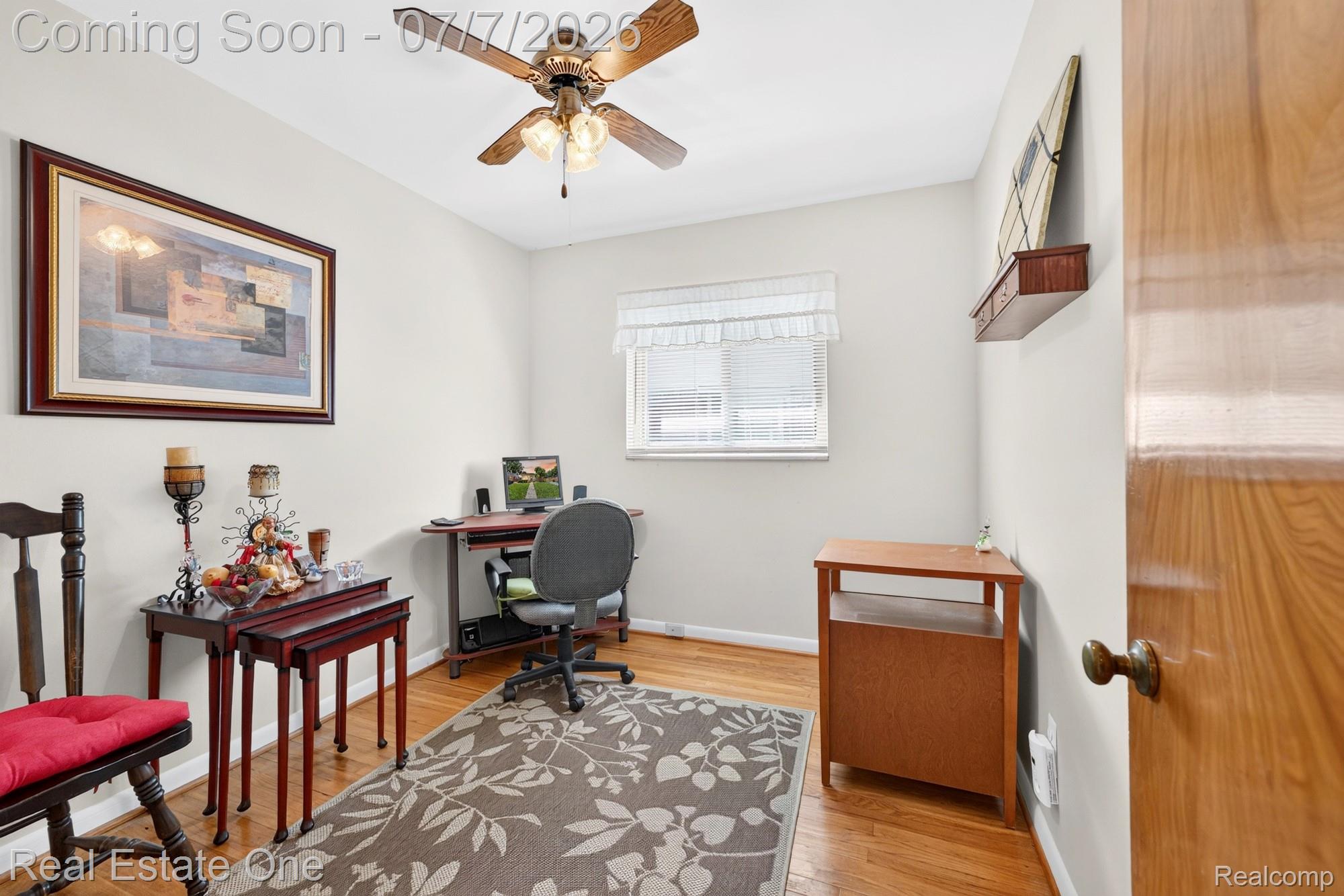 24749 Munson Street Taylor, MI 48180 - Photo 16 of 28 Room featuring wood-finish flooring, a ceiling fan with integrated lighting, a window with white blinds, and light-colored walls