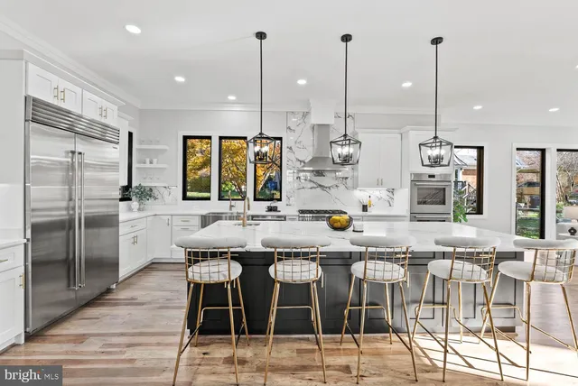a view of a hallway with white cabinets