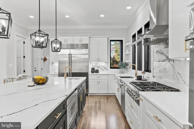 a living room with stainless steel appliances furniture and a large window