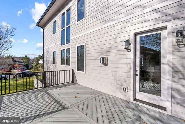 a view of a livingroom with a ceiling fan wooden floor and a ceiling fan
