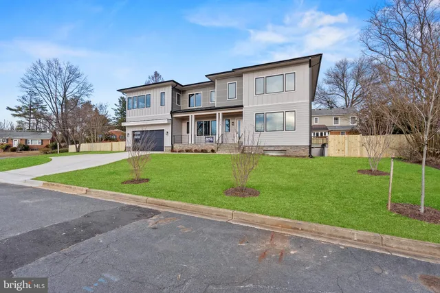 a living room with fireplace furniture and a large window