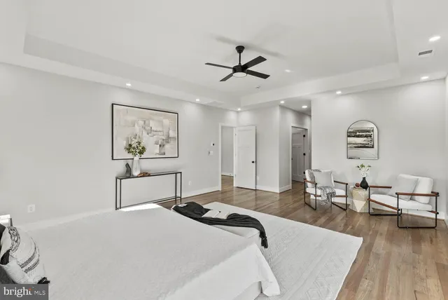 a bathroom with a bathtub shower sink vanity and toilet