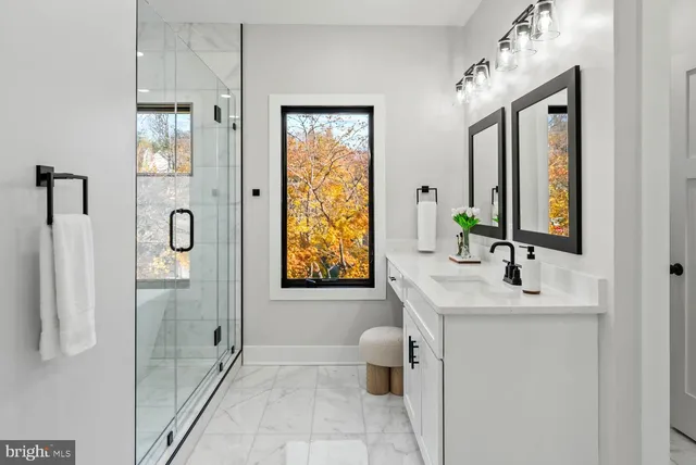 a bathroom with a double vanity sink shower and a mirror