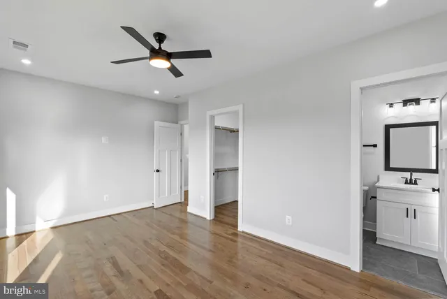 a view of room with wooden floor and white walls
