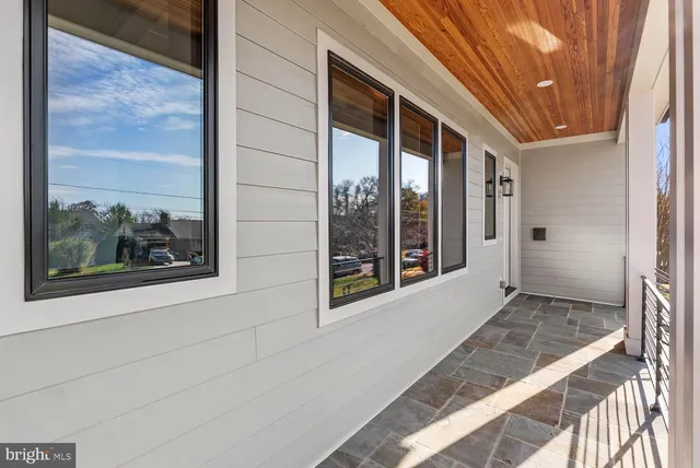 a living room with fireplace furniture and a large window