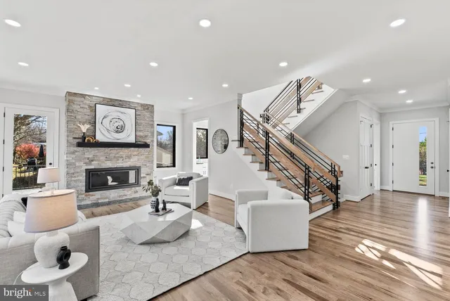 a living room with furniture and large windows