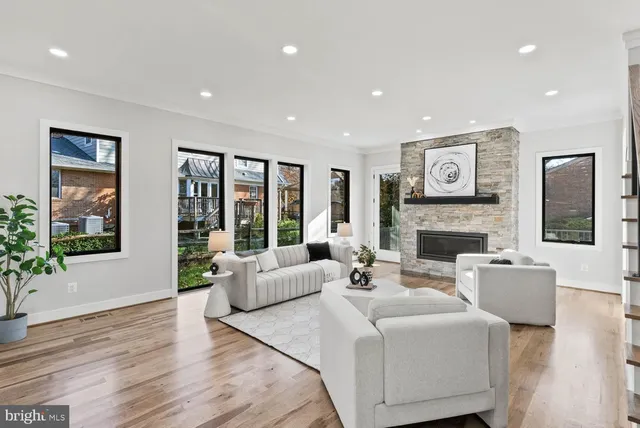a living room with furniture and a view of kitchen