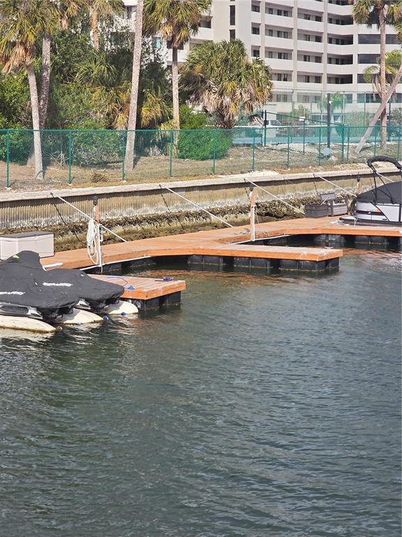 5915 Sea Ranch Drive, Unit 408 Hudson, FL 34667 - Photo 65 of 65 a view of swimming pool with outdoor seating and trees in the background