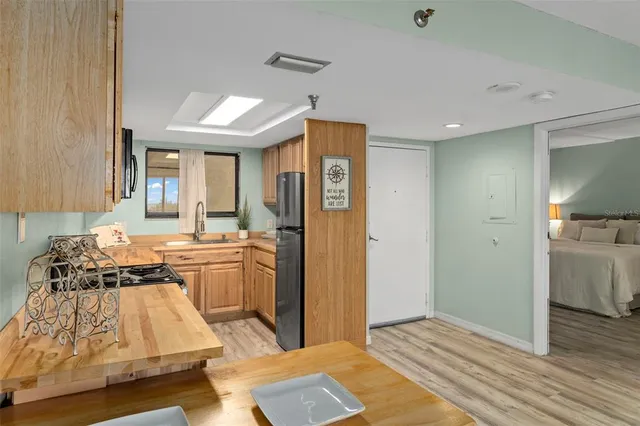 a kitchen with stainless steel appliances granite countertop a sink stove and microwave