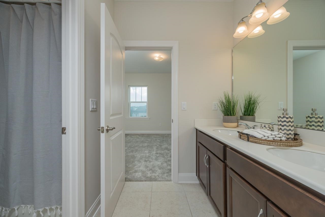 194 Snowbell Court St. Augustine, FL 32095 - Photo 16 of 75 a bathroom with a sink and a mirror