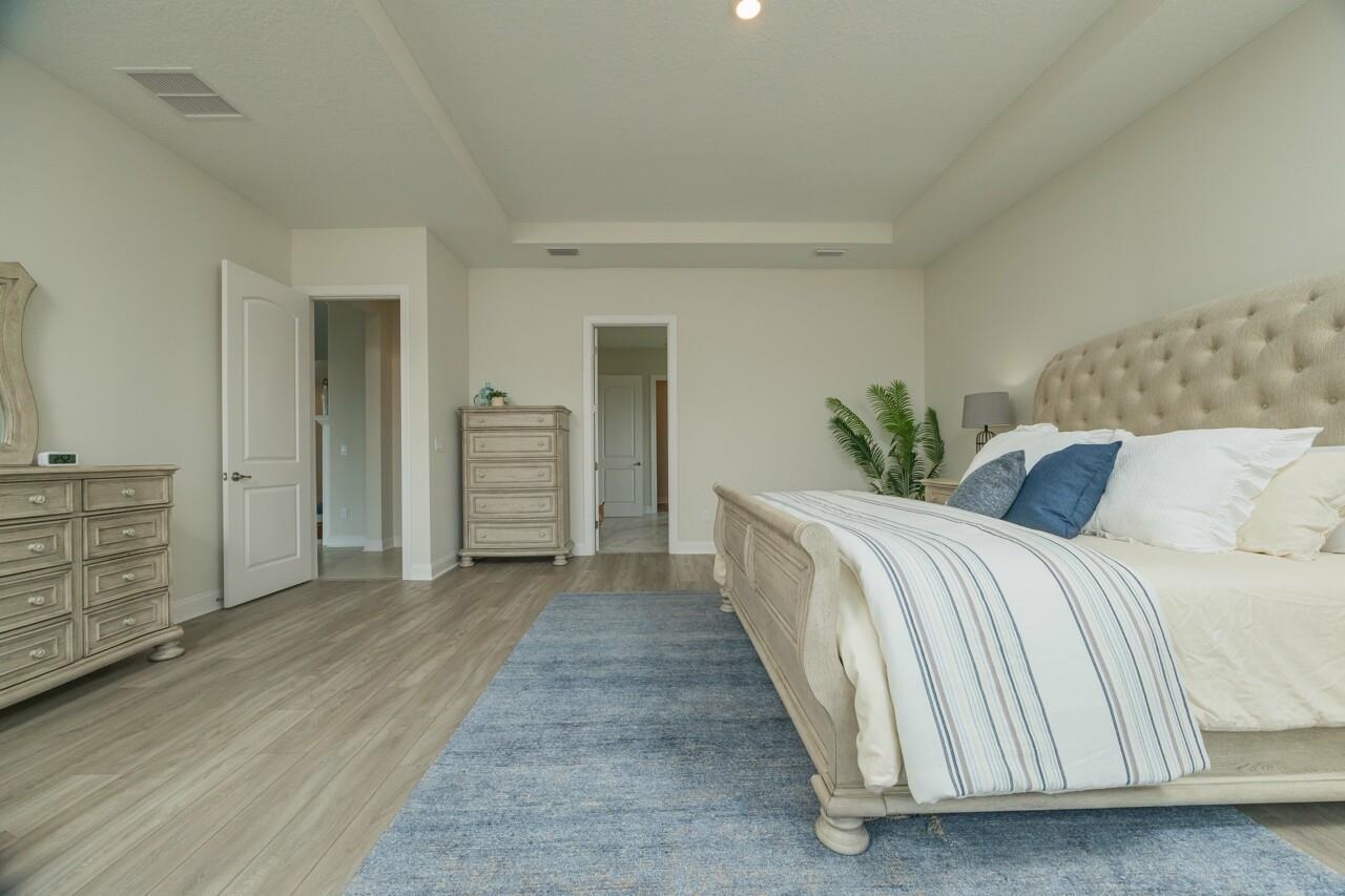 194 Snowbell Court St. Augustine, FL 32095 - Photo 18 of 75 a spacious bedroom with a bed and closet