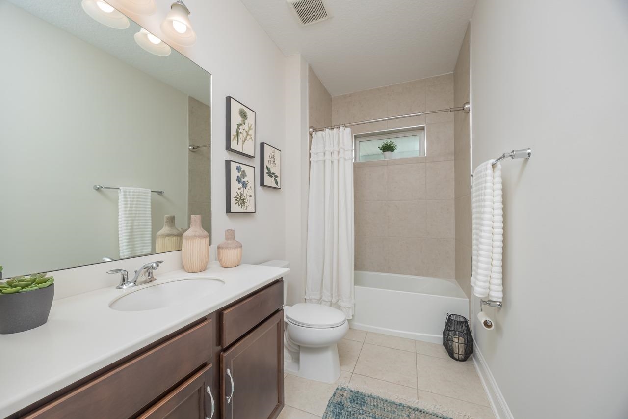 194 Snowbell Court St. Augustine, FL 32095 - Photo 28 of 75 a bathroom with a sink a toilet and shower