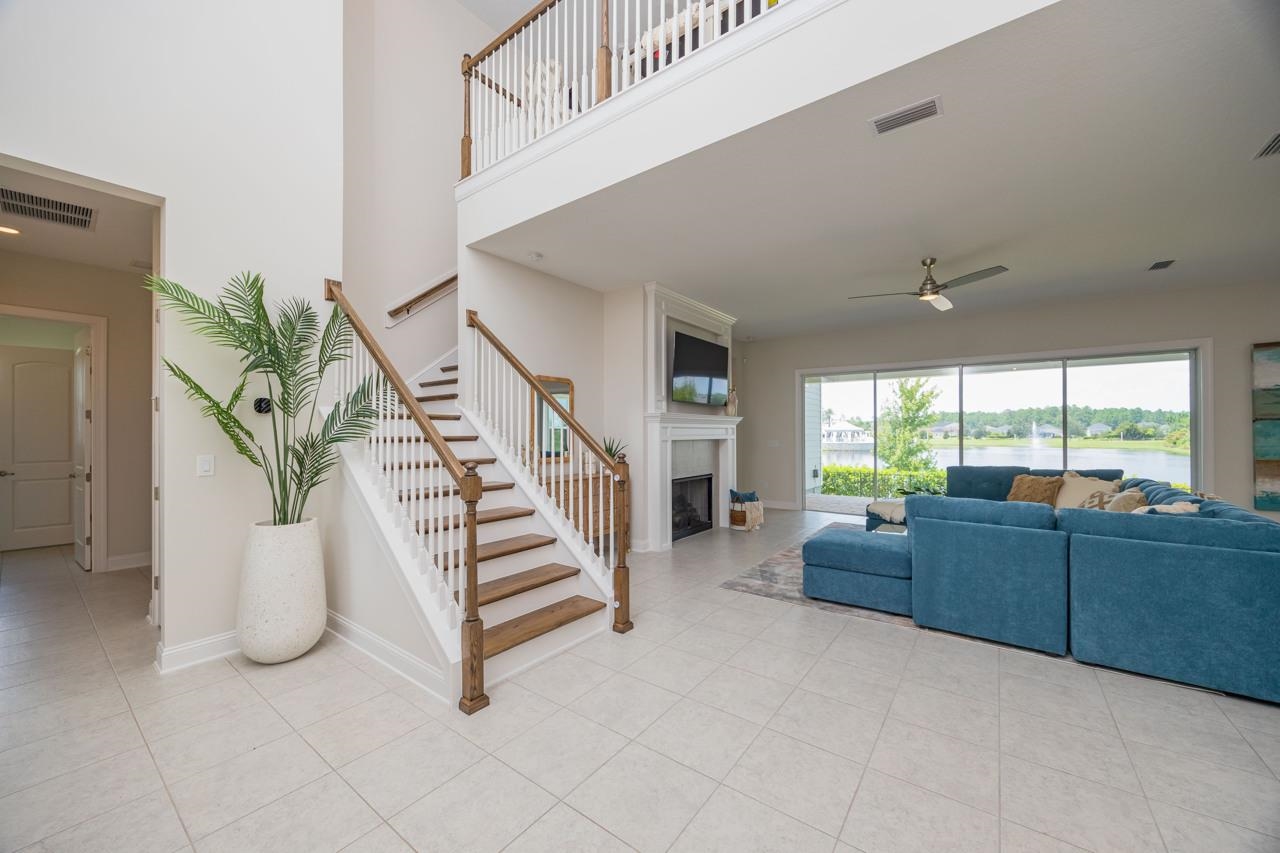 194 Snowbell Court St. Augustine, FL 32095 - Photo 49 of 75 a living room with furniture and stairs