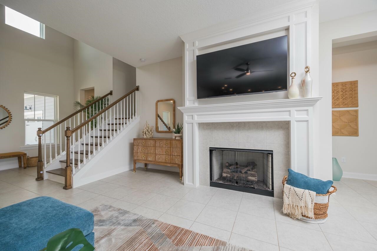 194 Snowbell Court St. Augustine, FL 32095 - Photo 52 of 75 a living room with a fireplace and a flat screen tv