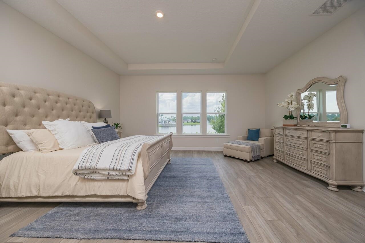 194 Snowbell Court St. Augustine, FL 32095 - Photo 7 of 75 a spacious bedroom with a bed and a large window