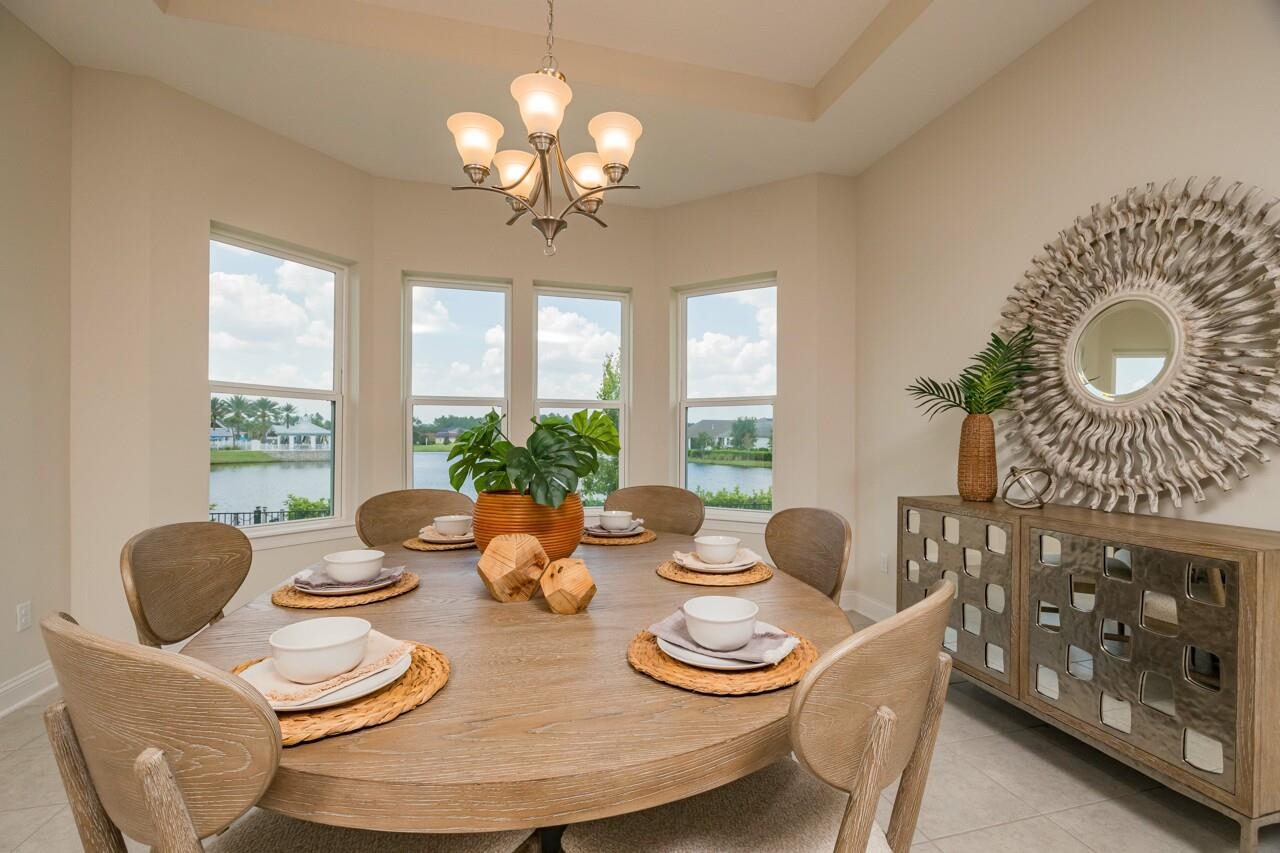 194 Snowbell Court St. Augustine, FL 32095 - Photo 8 of 75 a view of a dining room with furniture a chandelier and large windows