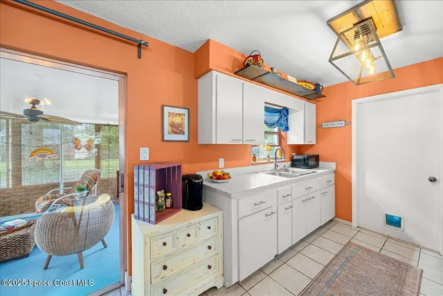 a kitchen with a sink cabinets and window