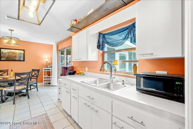 a kitchen with stainless steel appliances a stove a sink and a microwave