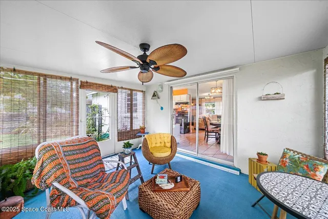 a living room with furniture a rug and a large window