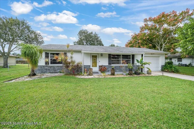 a front view of house with yard and green space