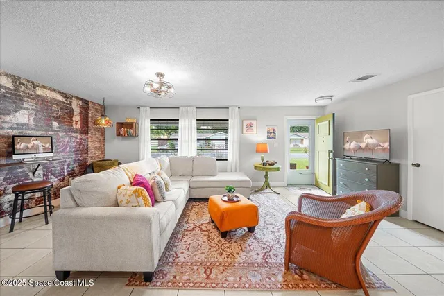 a living room with furniture potted plant and a fireplace