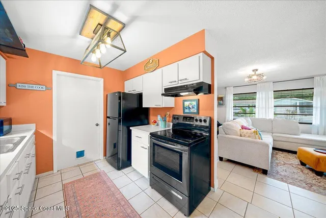 a kitchen with stainless steel appliances granite countertop a stove a refrigerator and a microwave