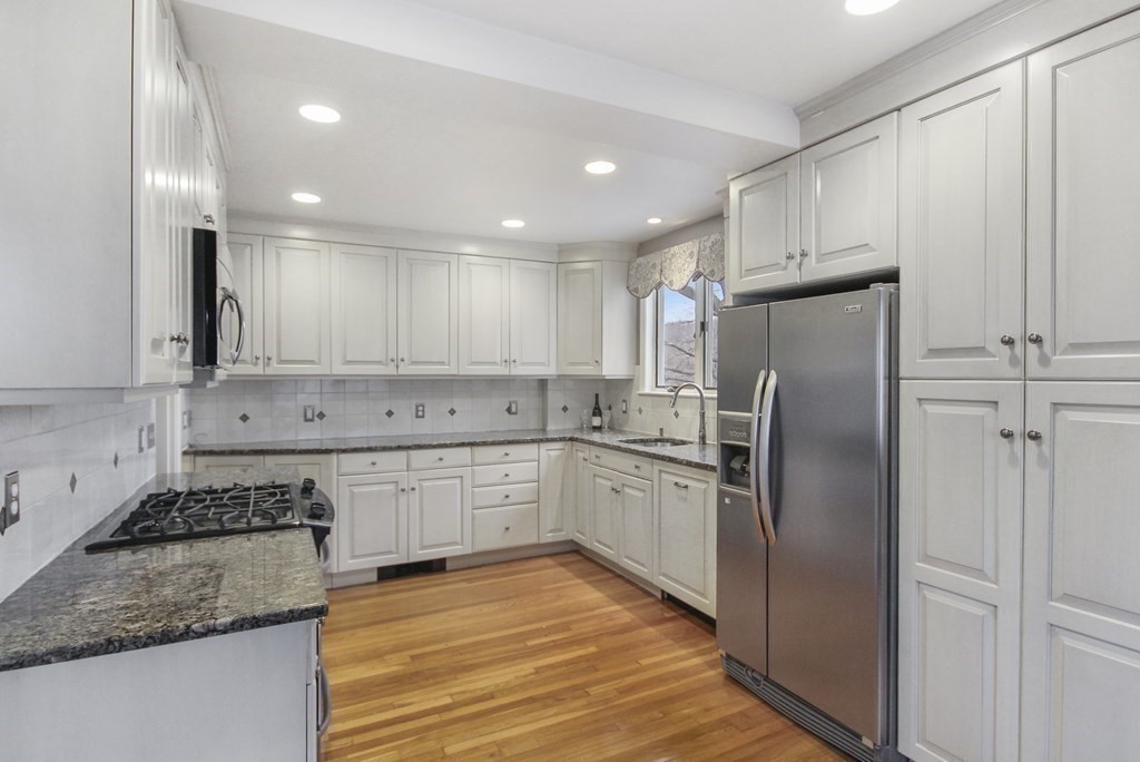 35 Standish Road Watertown, MA 02472 - Photo 9 of 33 a kitchen with stainless steel appliances granite countertop a refrigerator sink and cabinets