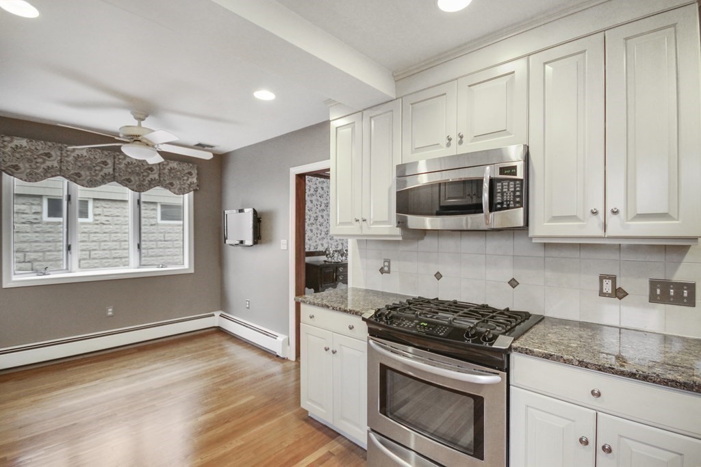 35 Standish Road Watertown, MA 02472 - Photo 10 of 33 a kitchen with stainless steel appliances granite countertop a stove a microwave and cabinets