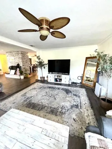 a view of a livingroom with furniture and a flat screen tv