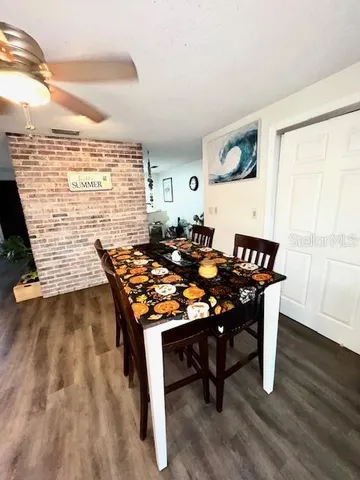 a dining room with furniture and wooden floor