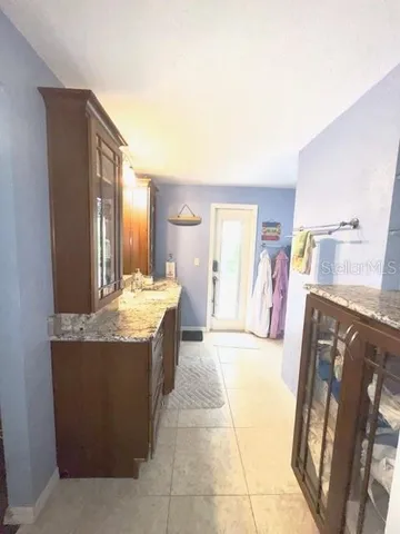 a large bathroom with a tub and sink