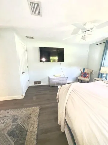 a bed room with a bed and a television