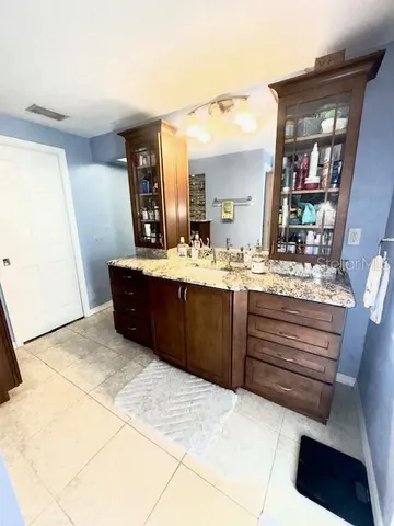 a bathroom with a sink vanity and mirror