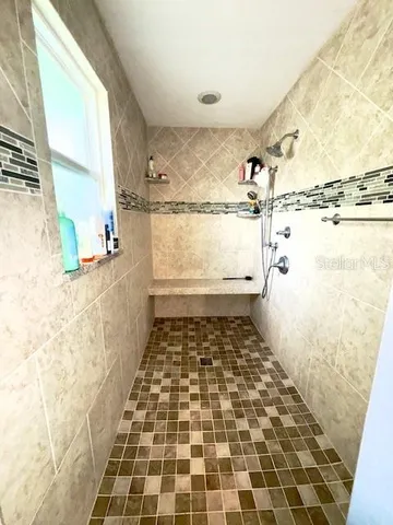 a bathroom with a glass door shower