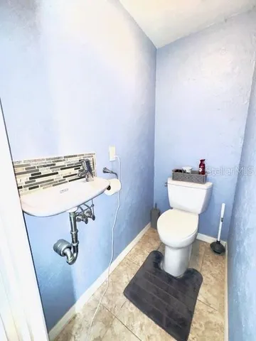 a bathroom with a sink mirror and toilet
